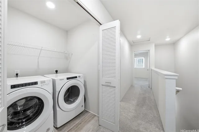 a view of a hallway with washer and dryer