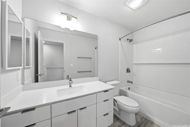 a bathroom with a sink toilet a mirror and shower