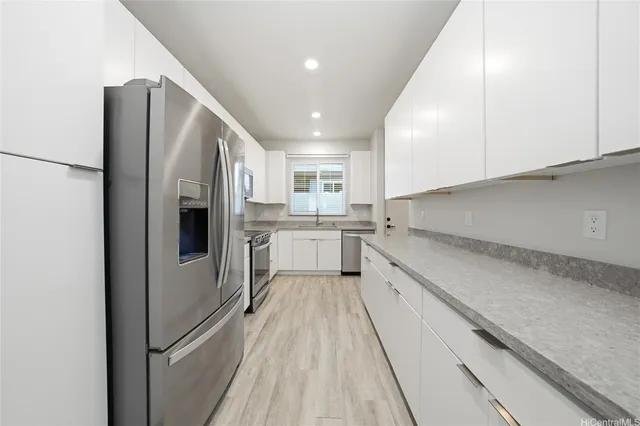 a kitchen with white cabinets and white appliances