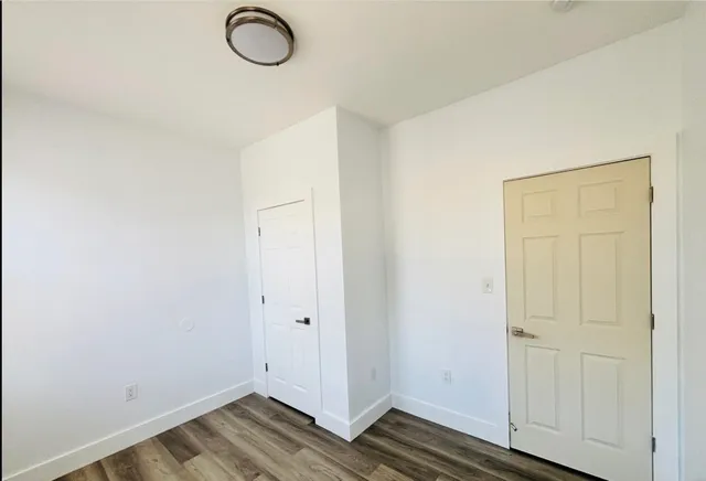 an empty room with wooden floor