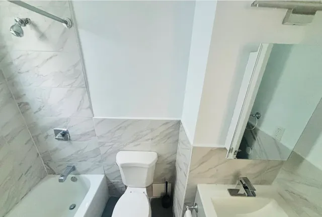 a bathroom with a sink toilet and shower