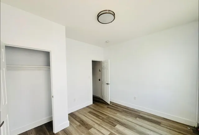 a view of a room with wooden floor