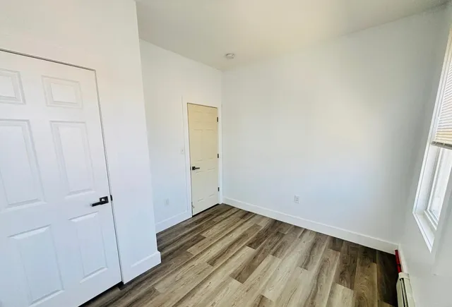 a view of a room with wooden floor