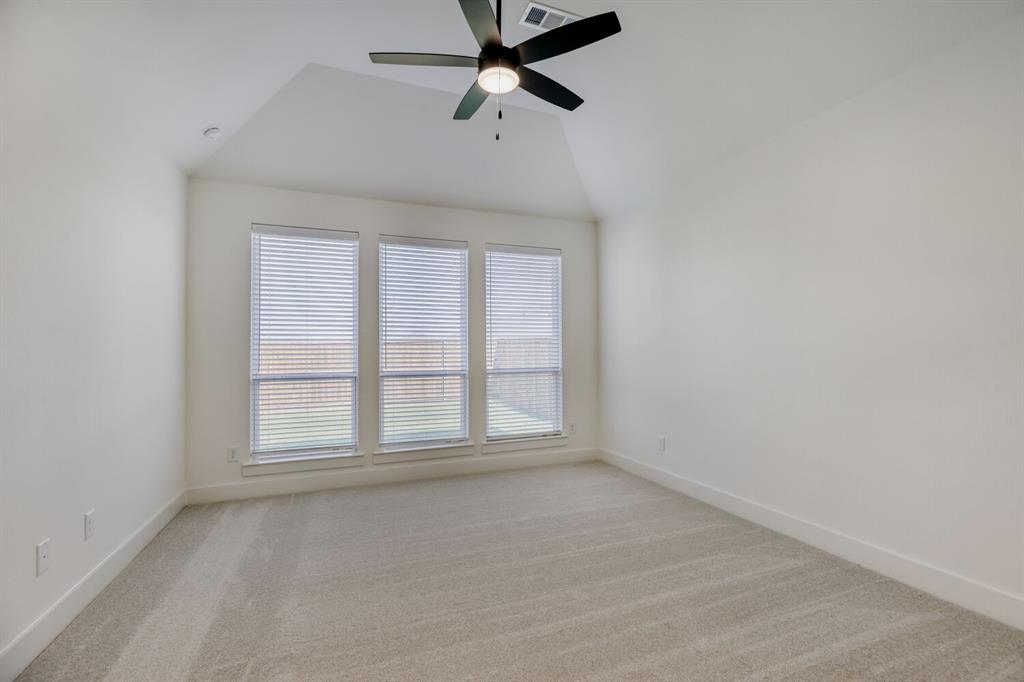 4314 Haley Way Oak Point, TX 75068 - Photo 13 of 28 Vaulted ceiling bedroom featuring a contemporary ceiling fan, three windows with horizontal blinds, neutral-toned carpeting, and white baseboards