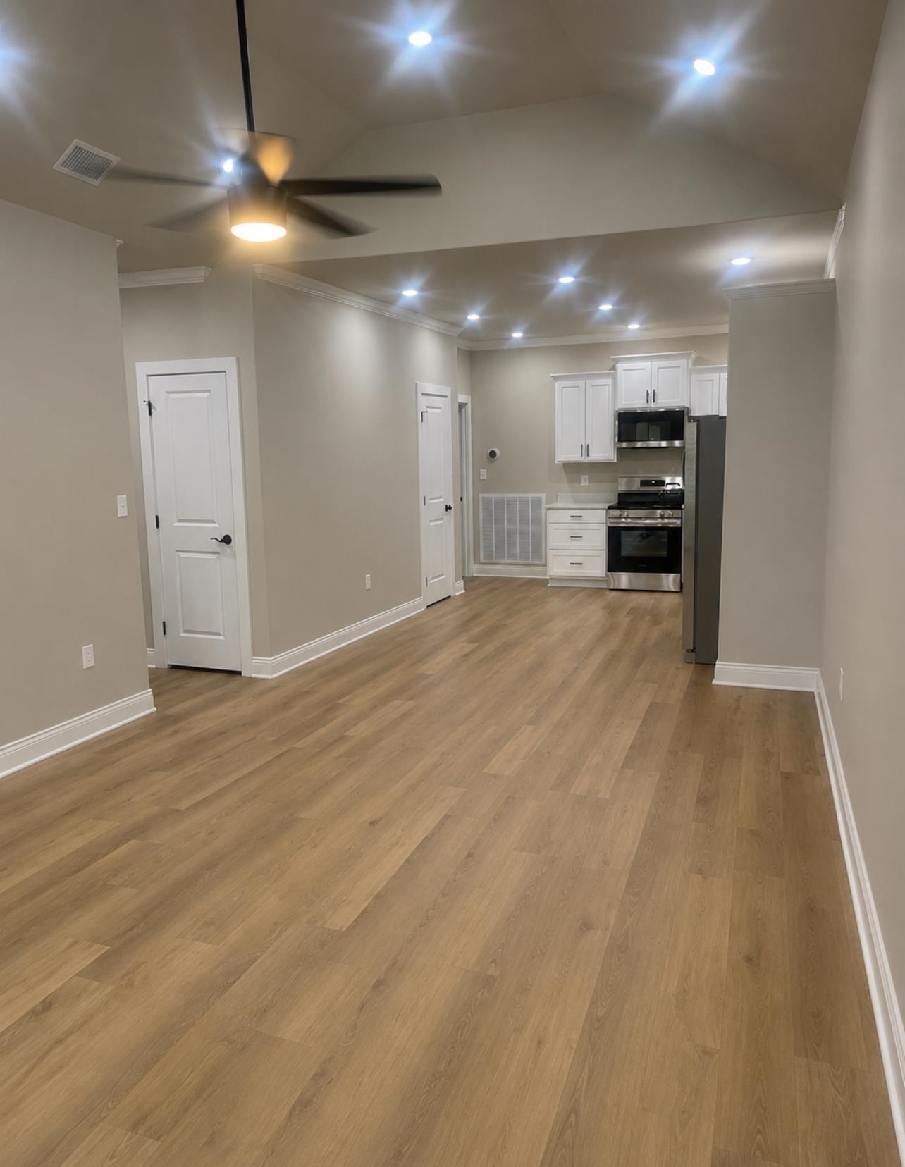 210 Church Street Ripley, TN 38063 - Photo 5 of 21 Spacious open-concept interior featuring wood-finish flooring, vaulted ceilings, and recessed lighting