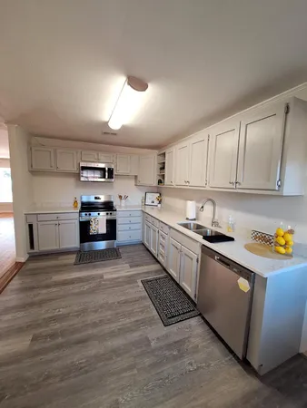 a kitchen with stainless steel appliances a stove top oven and cabinets