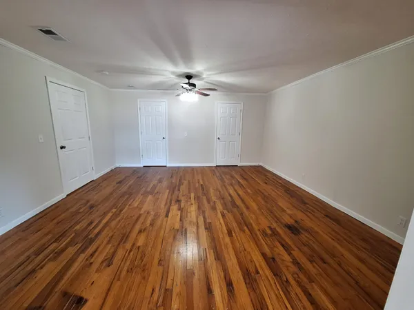 a view of a room with wooden floor