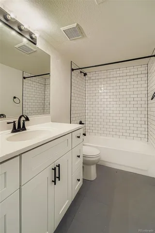 a bathroom with a double vanity sink toilet and shower