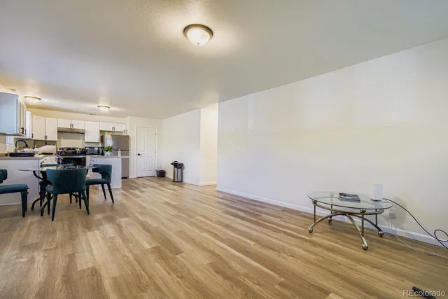 a kitchen with granite countertop a sink stove and refrigerator