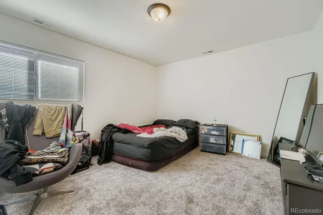 a bathroom with a sink a toilet a mirror and shower curtain