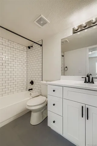 a bathroom with a double vanity sink toilet and shower