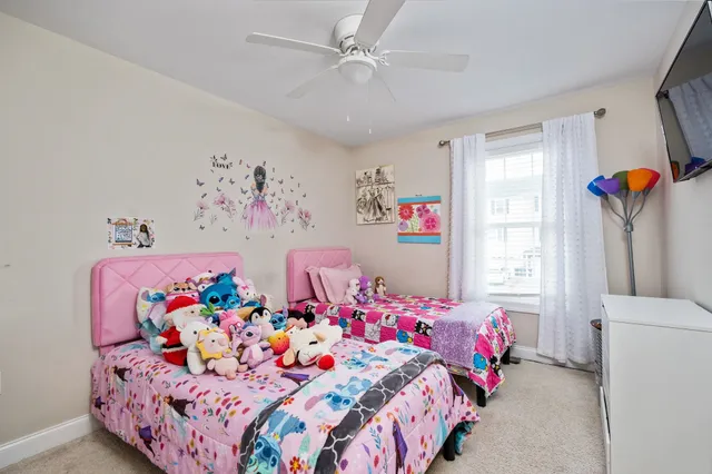 a bedroom with a bed and a dresser in it