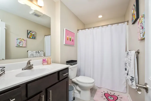 a bathroom with a sink a toilet and shower curtain