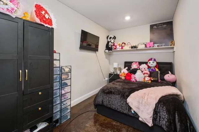 a bedroom with a bed and flat screen tv