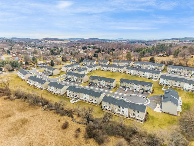 an aerial view of residential building and lake