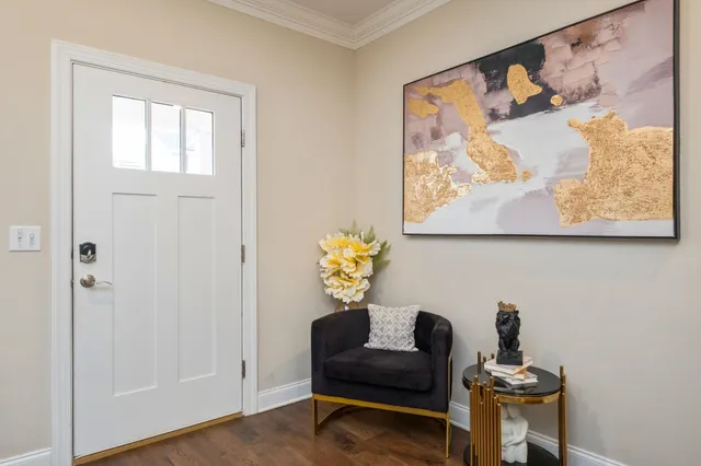 a living room with furniture and a painting on the wall