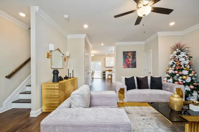 a living room with furniture and a chandelier