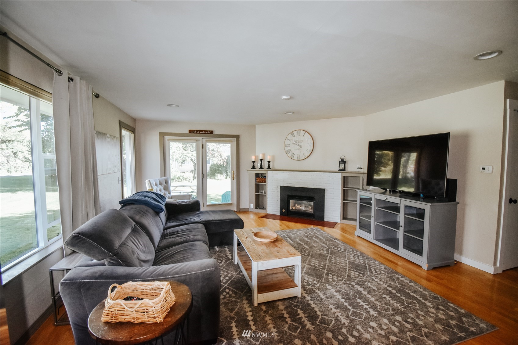 1375 West Smith Road Ferndale, WA 98248 - Photo 12 of 19 a living room with furniture a flat screen tv and a fireplace