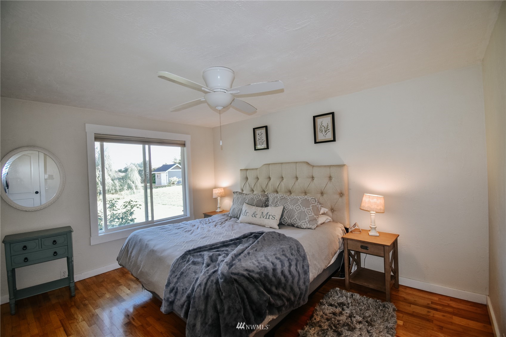 1375 West Smith Road Ferndale, WA 98248 - Photo 13 of 19 a bedroom with a bed a window and painting on the wall
