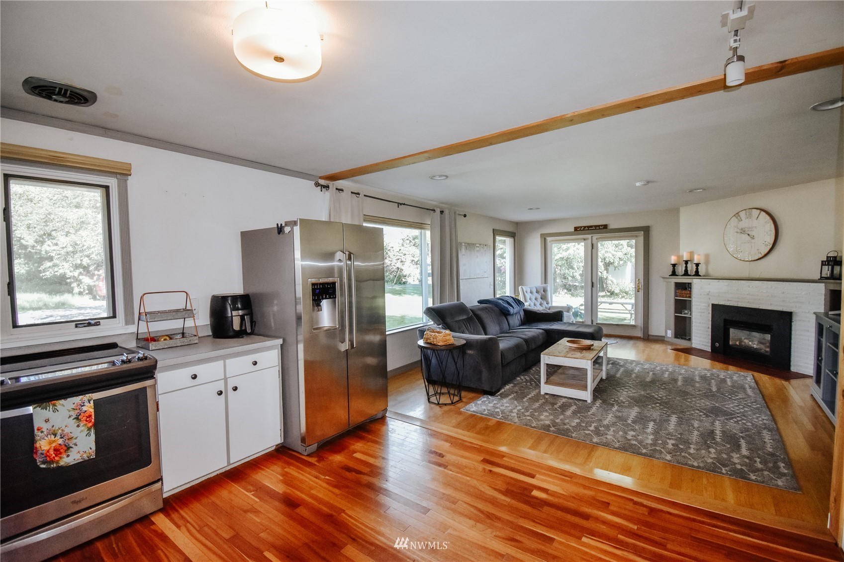 1375 West Smith Road Ferndale, WA 98248 - Photo 9 of 19 a living room with furniture wooden floor and a fireplace