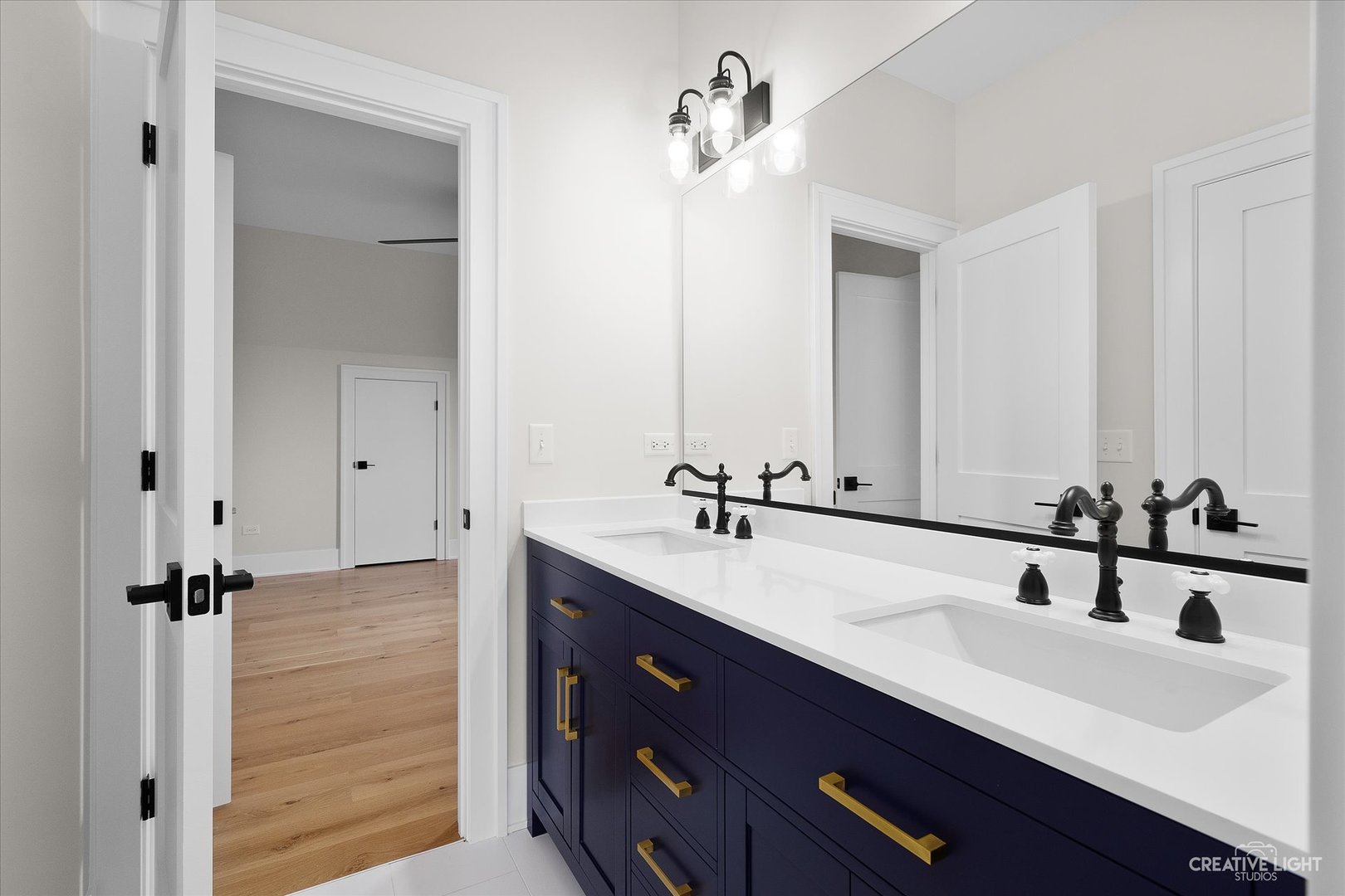 4764 Minooka Road Minooka, IL 60447 - Photo 25 of 39 a bathroom with a double vanity sink a mirror and shower