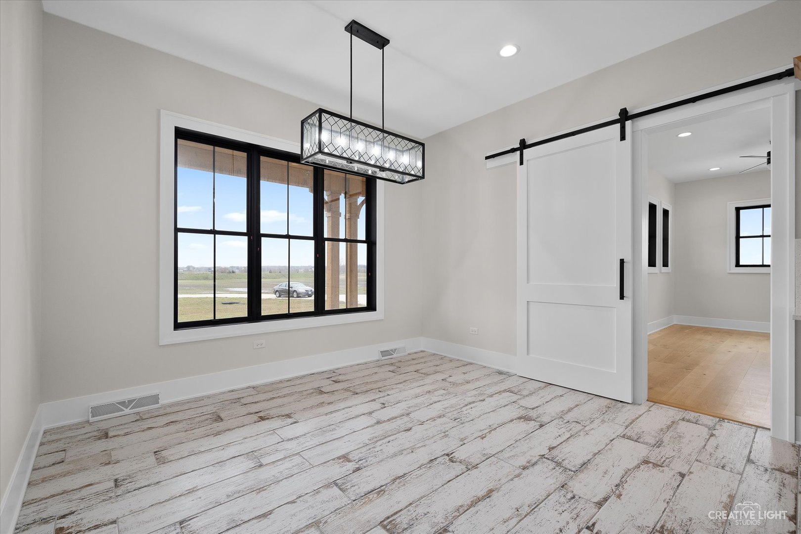 4764 Minooka Road Minooka, IL 60447 - Photo 10 of 39 a view of empty room with wooden floor and window