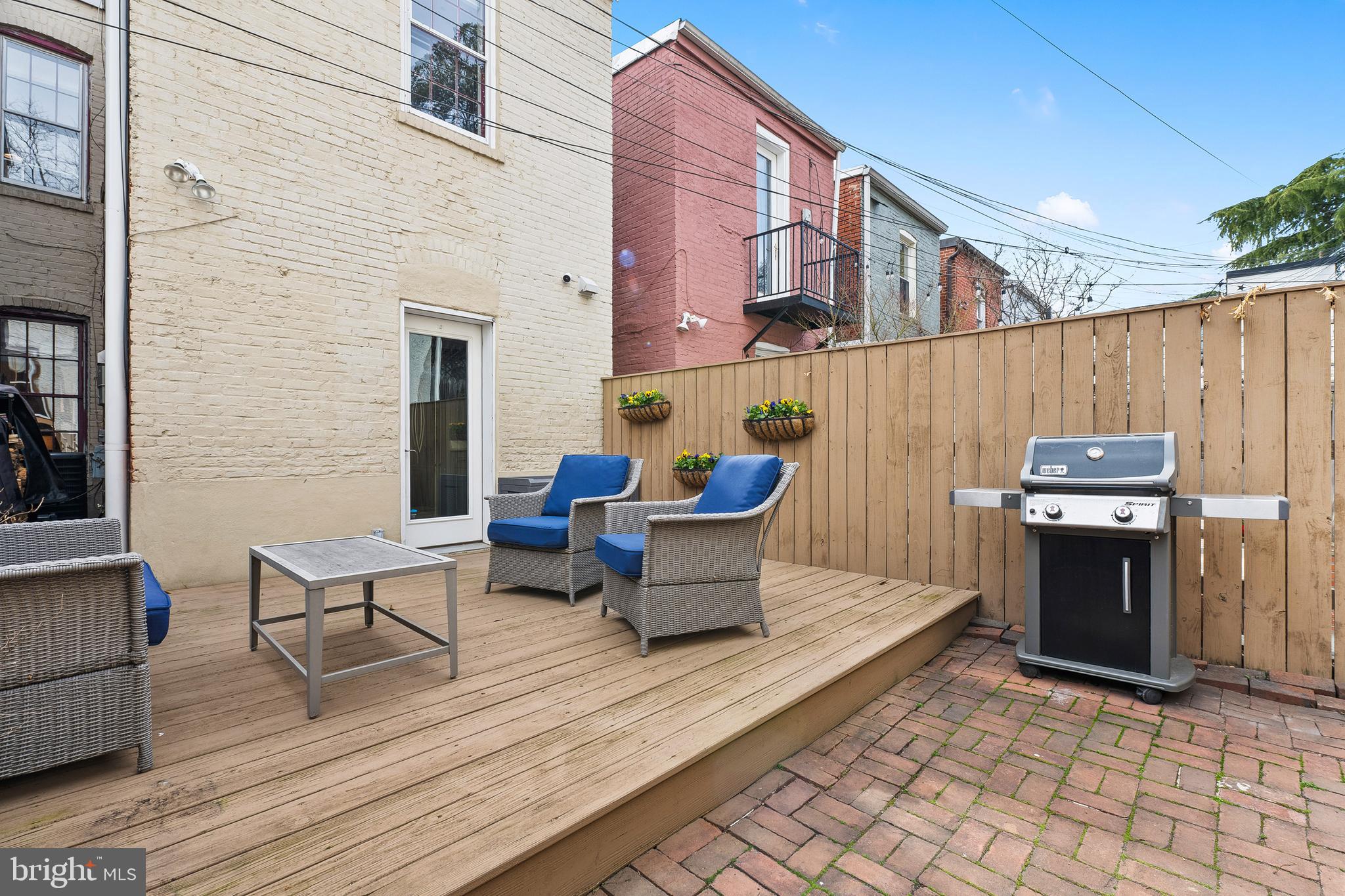 520 D Street Northeast Washington, DC 20002 - Photo 14 of 15 a backyard of a house with barbeque oven and outdoor seating