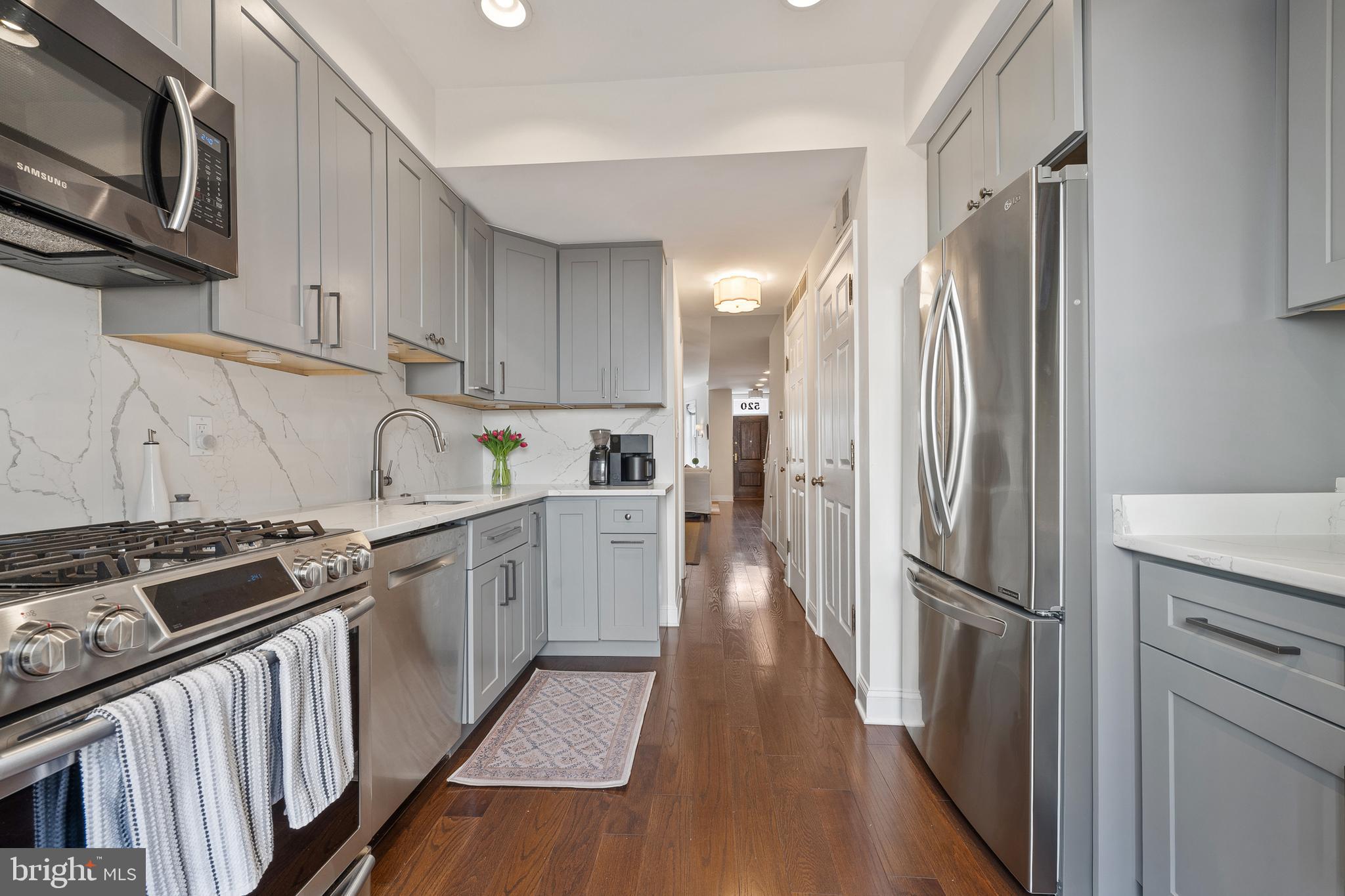 520 D Street Northeast Washington, DC 20002 - Photo 5 of 15 a kitchen with stainless steel appliances granite countertop a refrigerator stove and sink