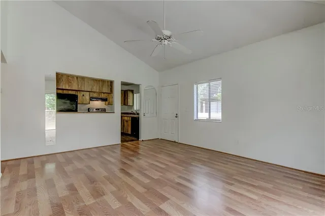 a view of a kitchen with a sink cabinets and wooden floor