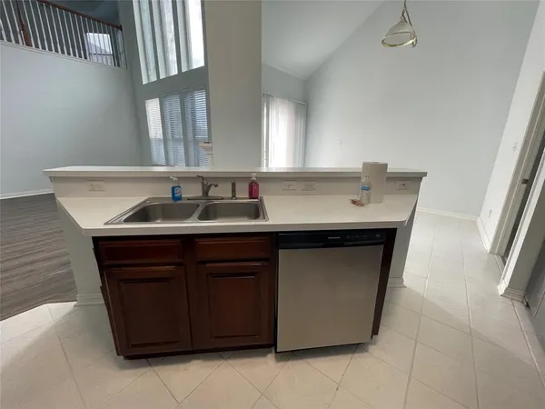 a kitchen with a sink and a mirror