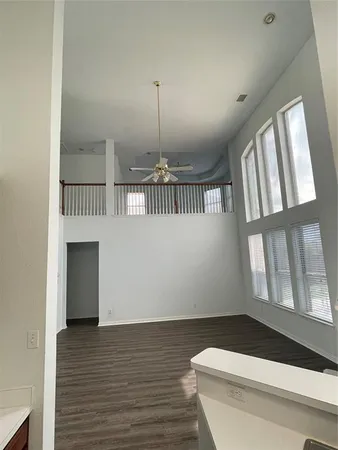 a view of entryway with a floor to ceiling window and wooden floor