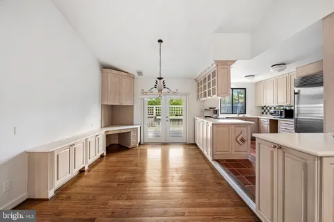 a kitchen with white cabinets and white appliances
