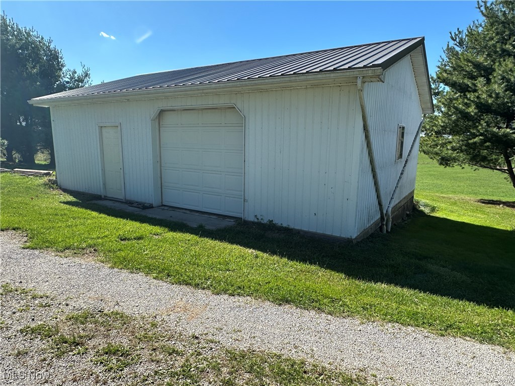 59558 Sandy Ridge Road Barnesville, OH 43713 - Photo 7 of 46 Garage featuring a yard and wooden walls