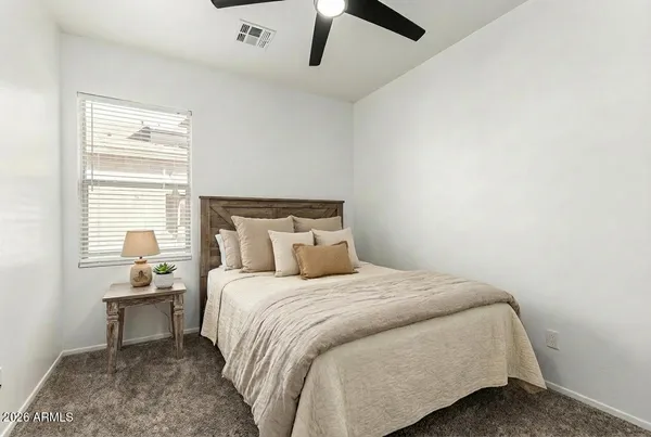 a bedroom with a bed and a window