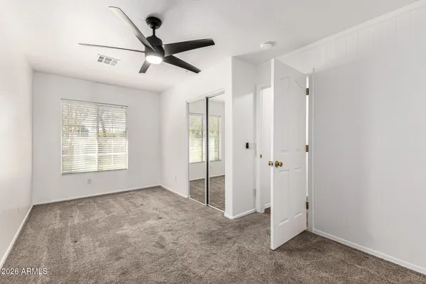 a view of empty room with ceiling fan