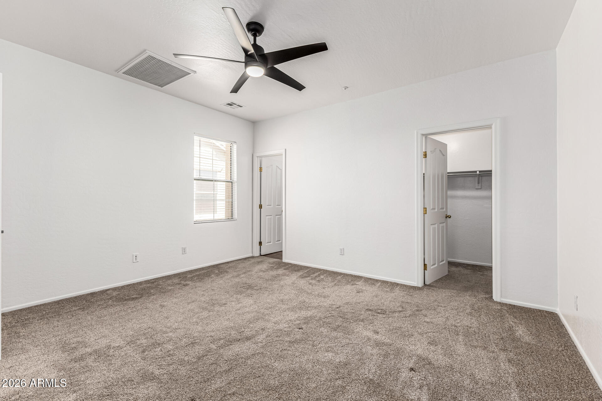 970 West Aspen Way Gilbert, AZ 85233 - Photo 20 of 36 an empty room with a ceiling fan and windows