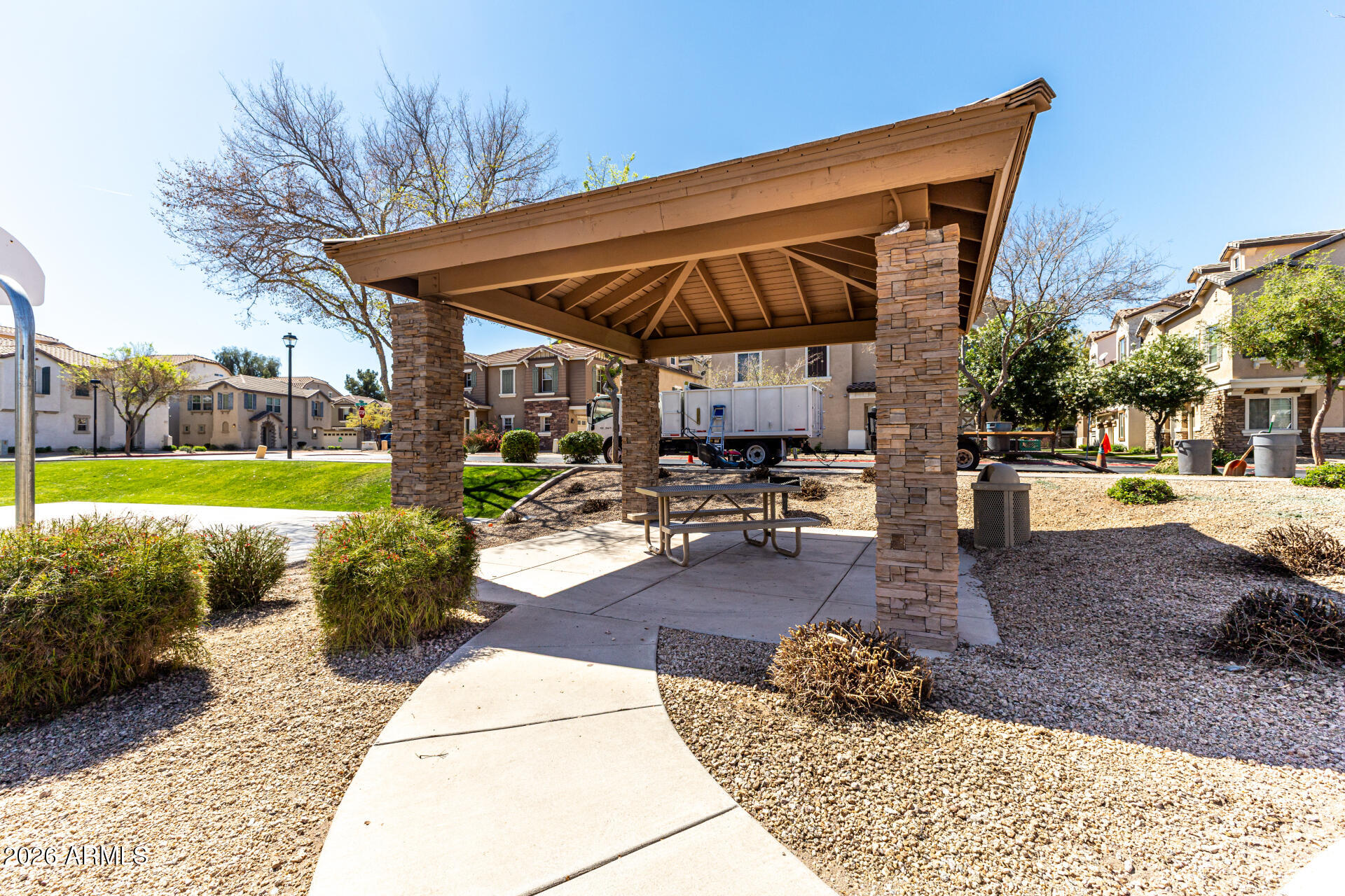 970 West Aspen Way Gilbert, AZ 85233 - Photo 30 of 36 a patio with table and chairs and potted plants