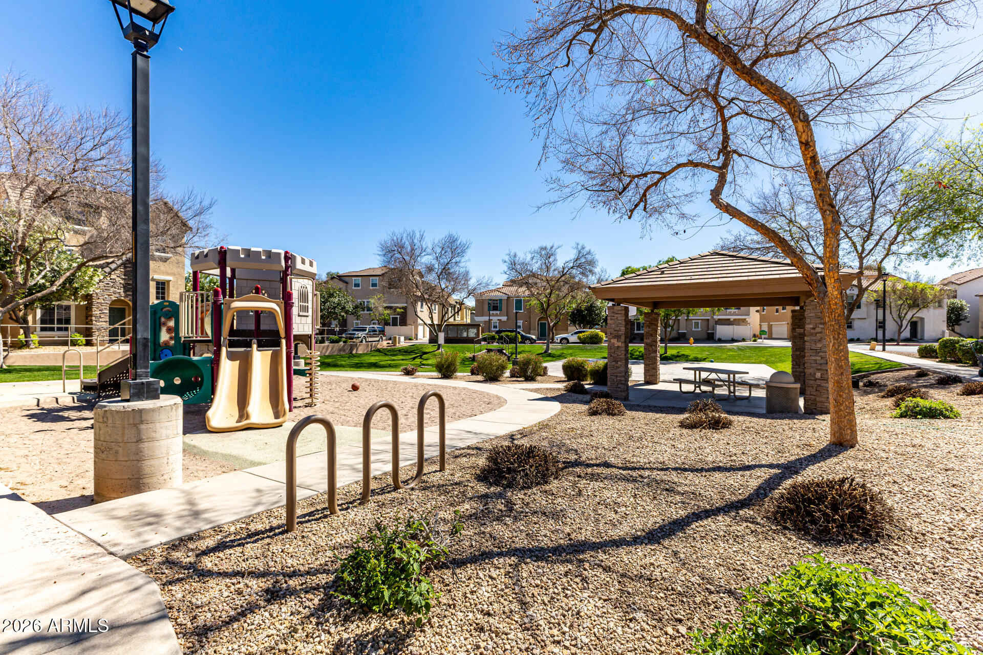 970 West Aspen Way Gilbert, AZ 85233 - Photo 32 of 36 a view of a patio with a table and chairs and a fire pit