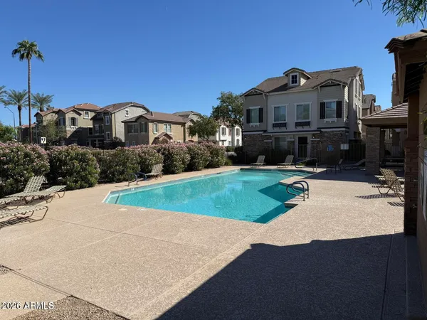 a view of a house with pool and a yard
