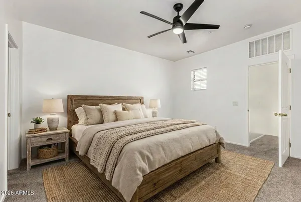 a bedroom with bed and a chandelier