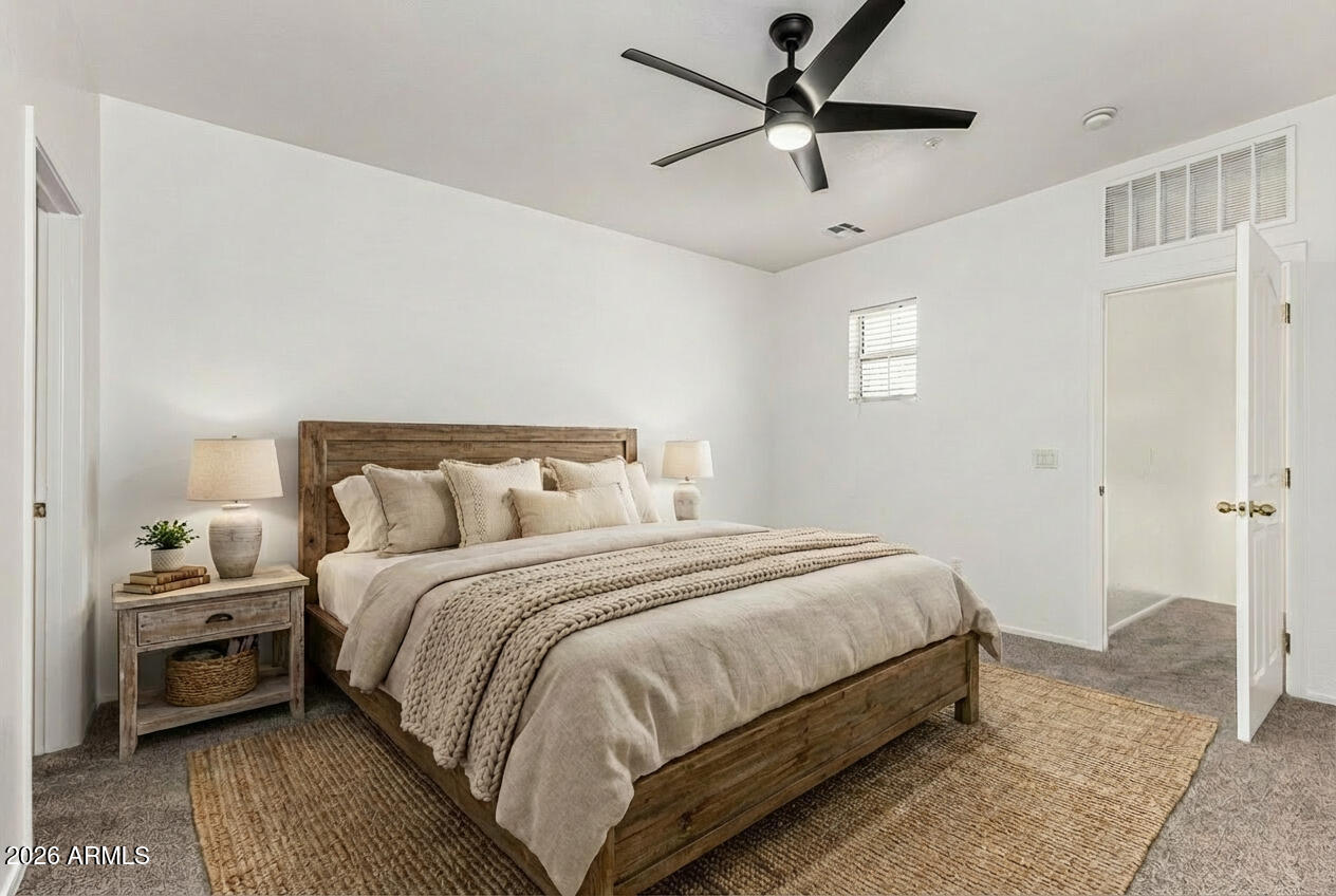 970 West Aspen Way Gilbert, AZ 85233 - Photo 4 of 36 a bedroom with bed and a chandelier