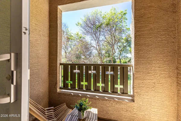 a front view of a house with balcony and garden