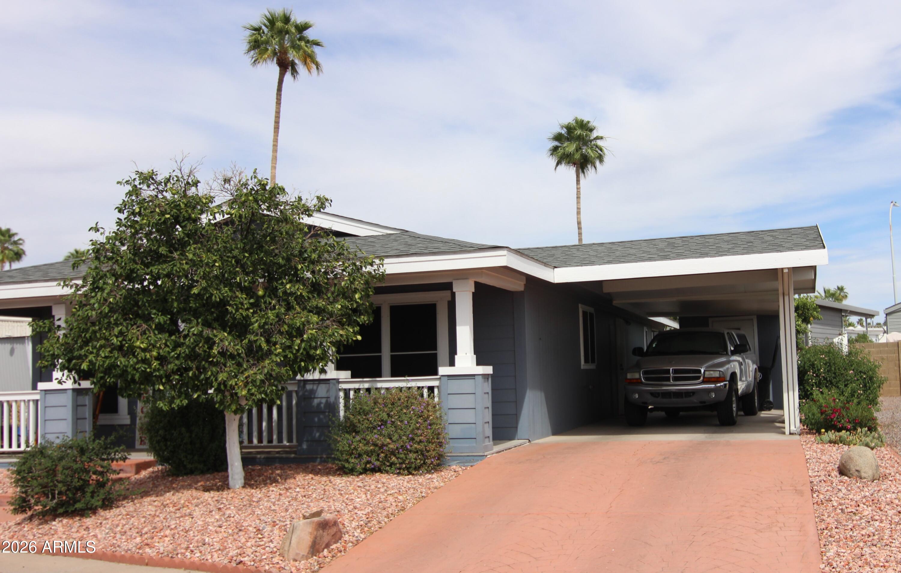201 South Greenfield Road, Unit 268 Mesa, AZ 85206 - Photo 3 of 22 a front view of a house with a garden and plants