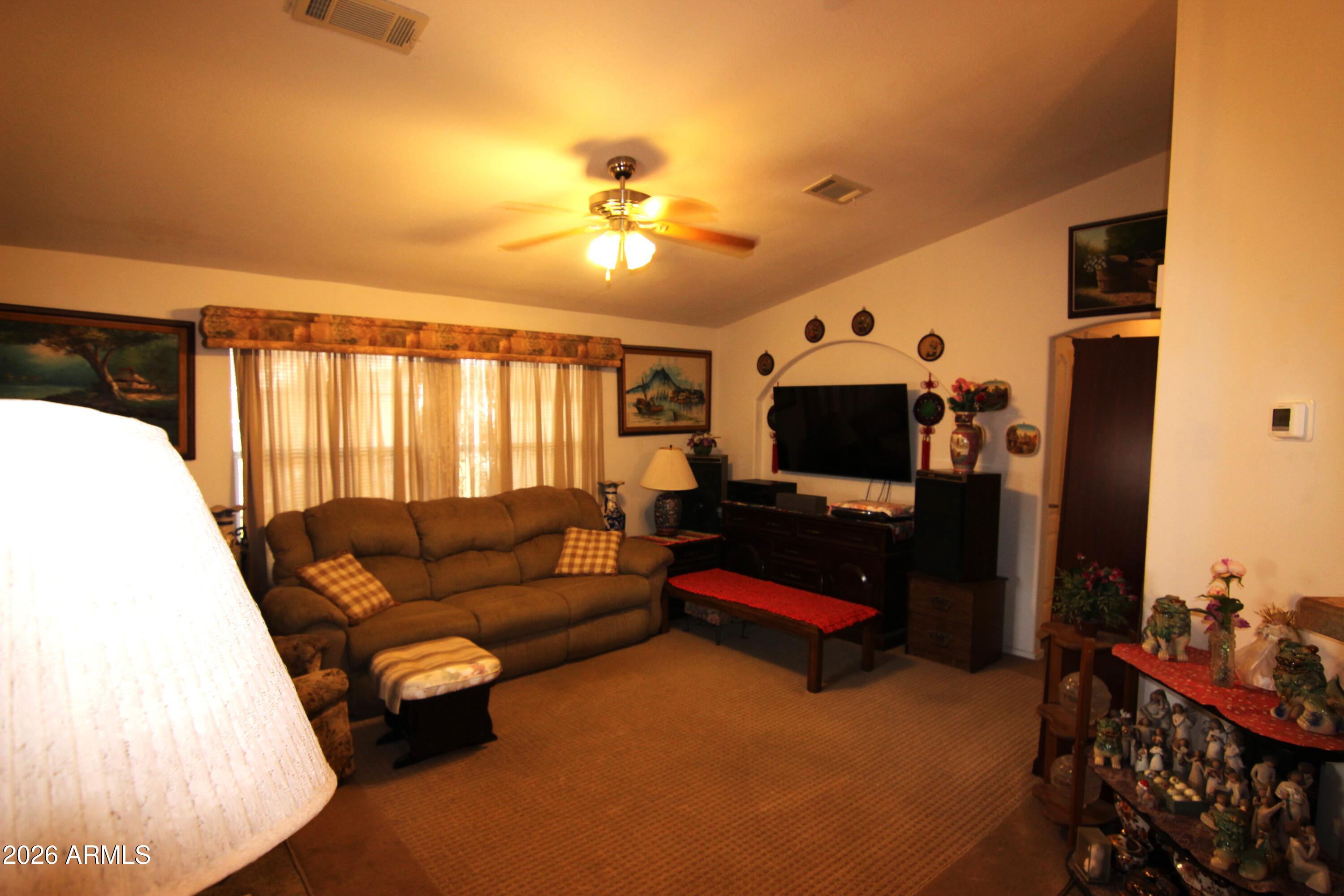 201 South Greenfield Road, Unit 268 Mesa, AZ 85206 - Photo 6 of 22 a living room with furniture and a flat screen tv