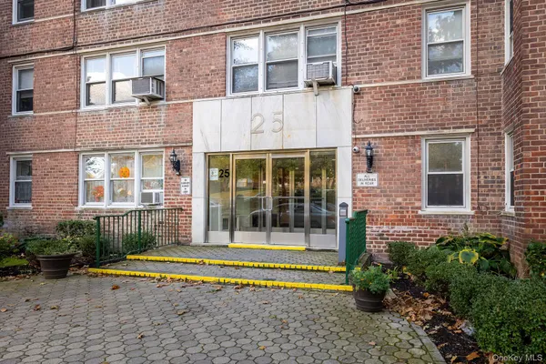 a view of a brick building next to a yard