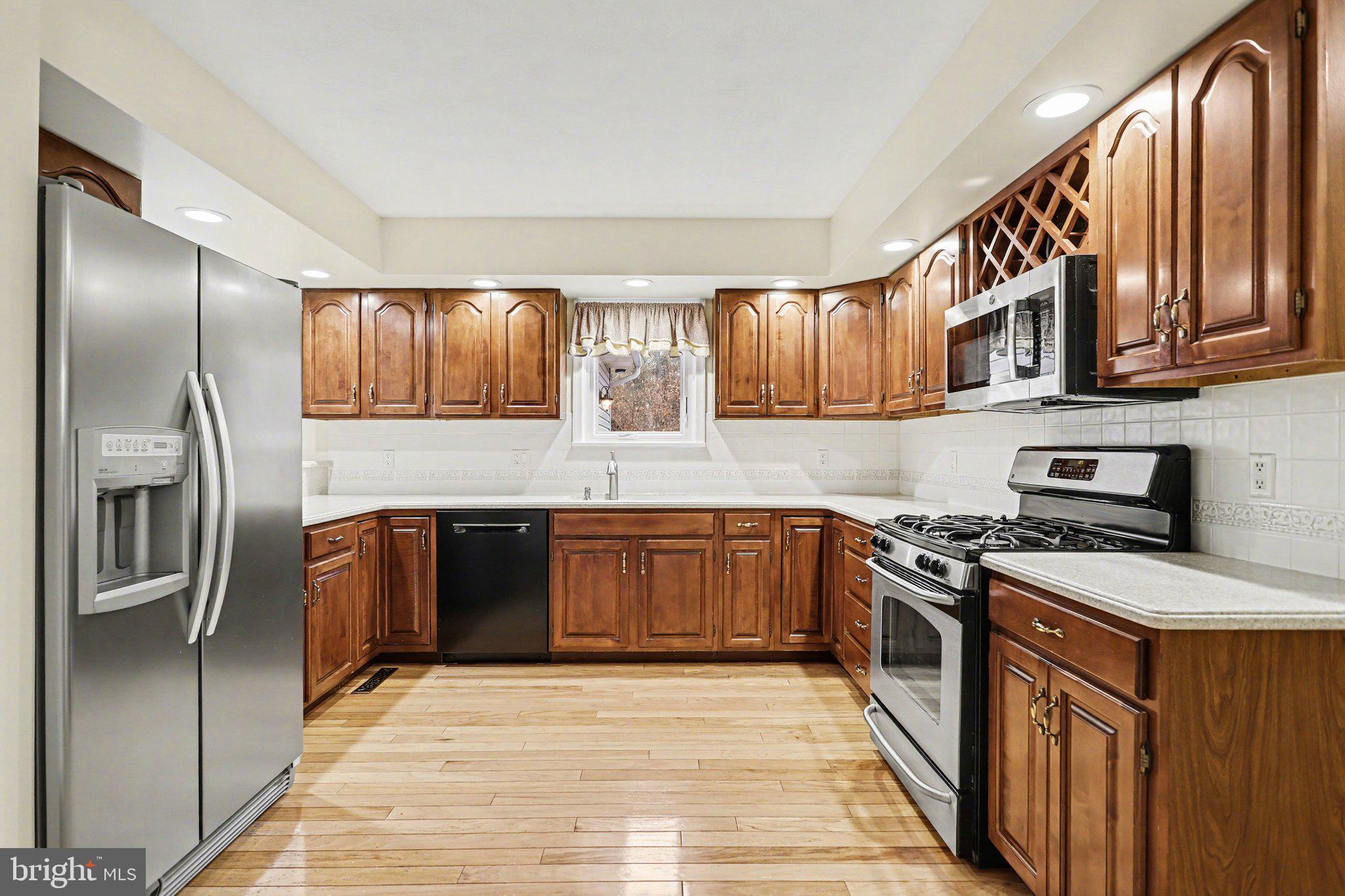 75 Longview Boulevard Gettysburg, PA 17325 - Photo 13 of 47 a kitchen with stainless steel appliances granite countertop a refrigerator a sink a stove a oven and cabinets