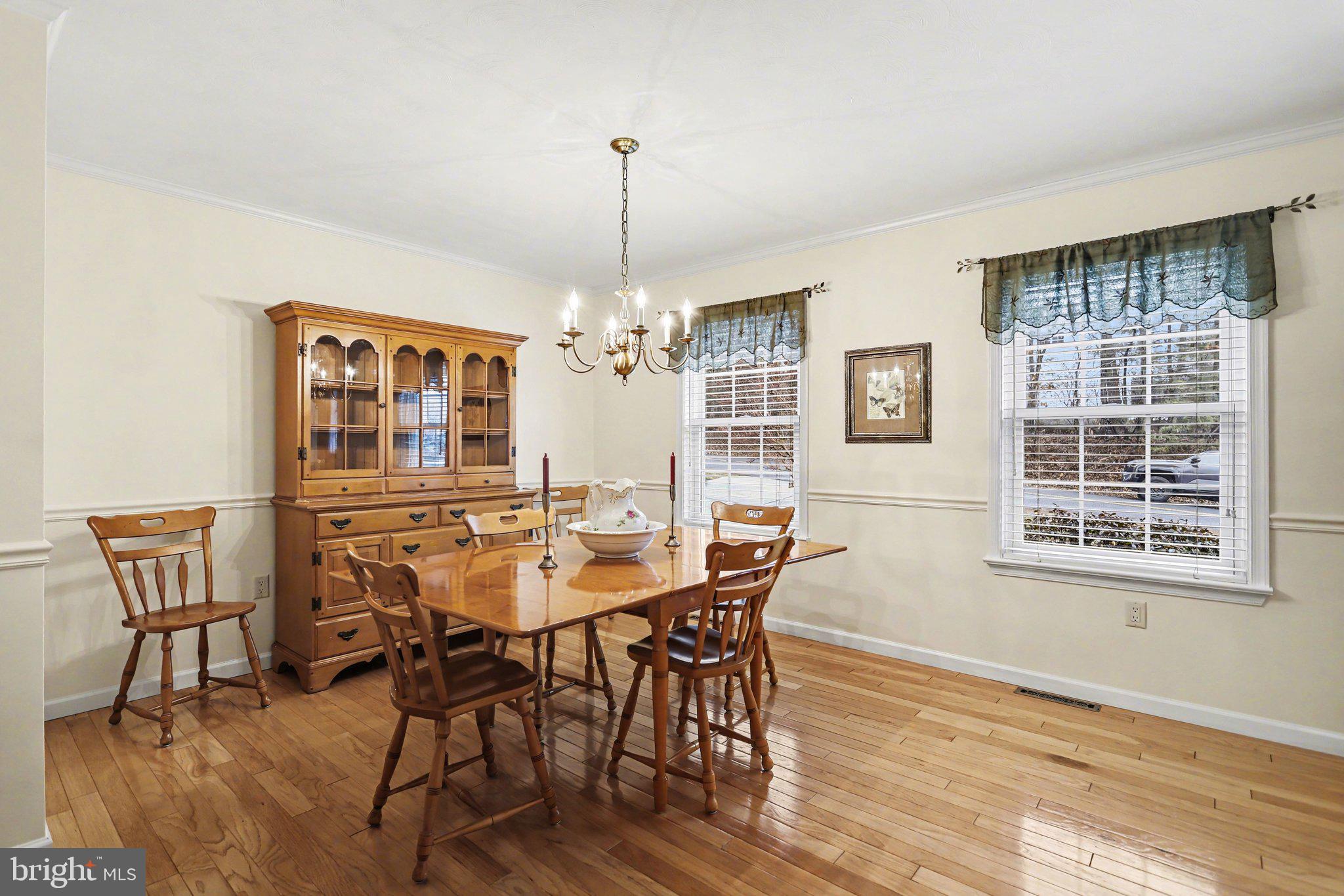 75 Longview Boulevard Gettysburg, PA 17325 - Photo 9 of 47 a view of a dining room with furniture a chandelier and wooden floor