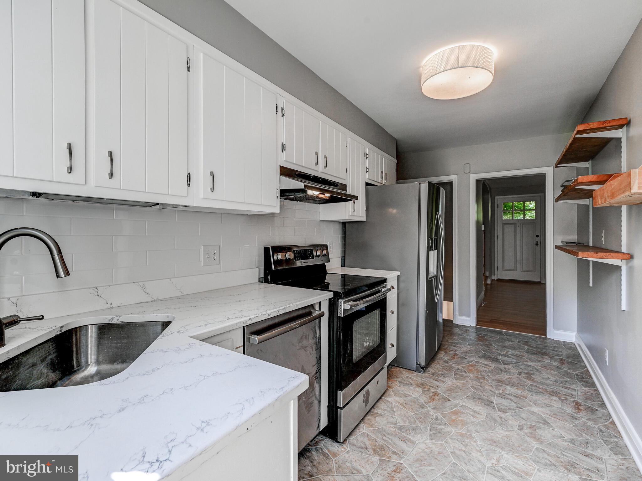 111 Stanmore Road Baltimore, MD 21212 - Photo 13 of 29 a kitchen with stainless steel appliances granite countertop a refrigerator sink and stove