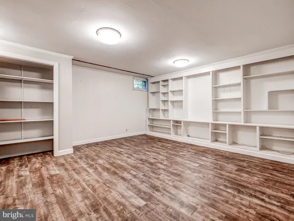 a view of an empty room with empty shelves