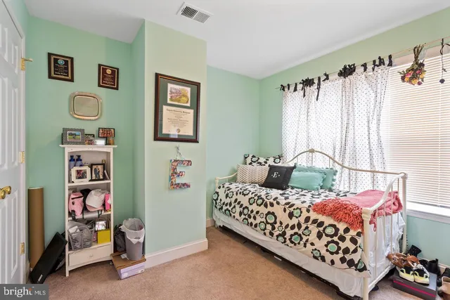 a bedroom with bed and a window